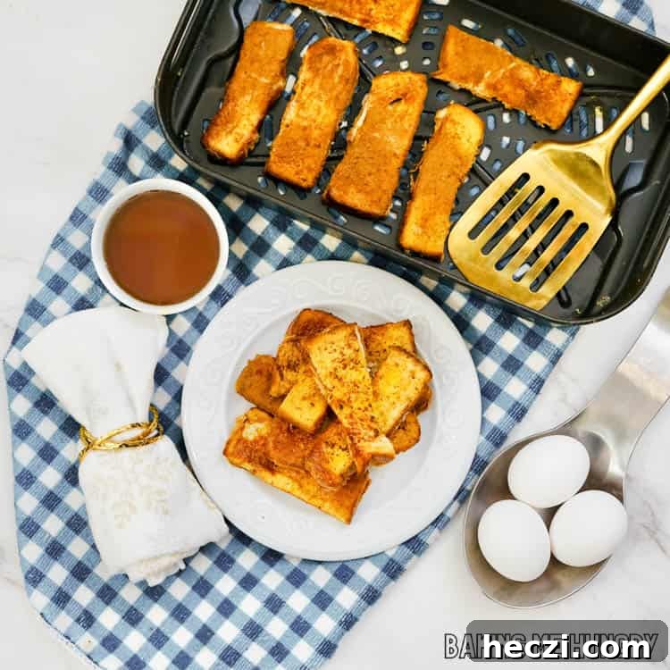 overheads shot of french toast sticks air fryer recipe served on a plate and shown in air fryer basket