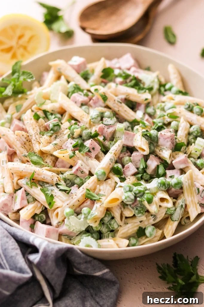 Close up of creamy ham and pea pasta salad