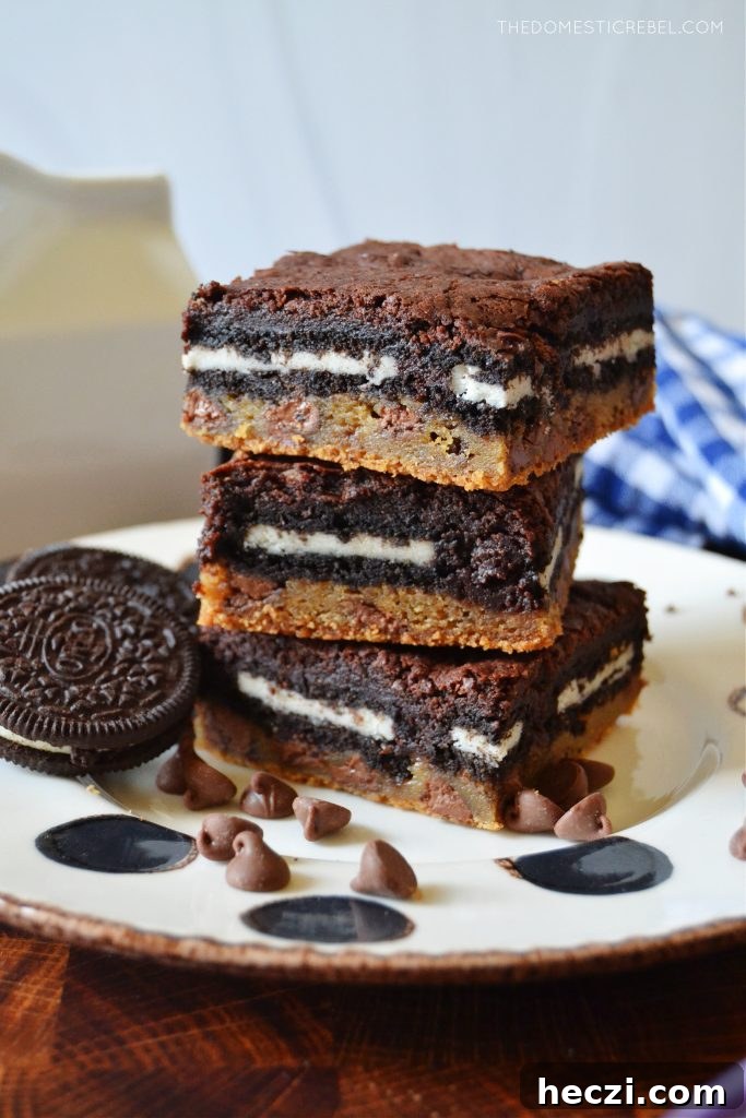 Decadent Homemade Slutty Brownies Recipe 6 a triple stack of slutty brownies on a white polka dot plate