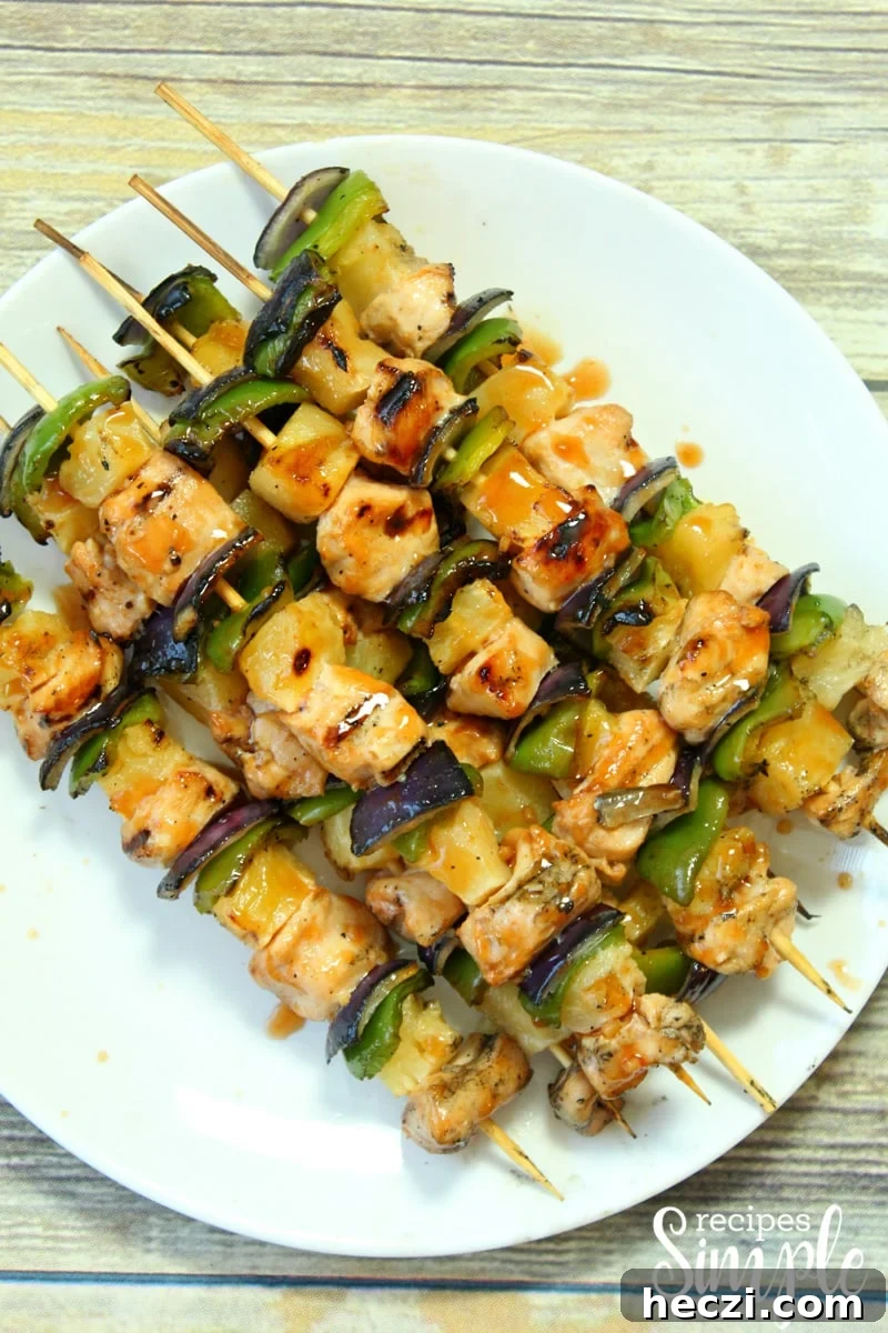 Hawaiian Chicken Kabobs with Pineapple Glaze — Grilled Recipe 3 Chicken Skewers on white serving platter.