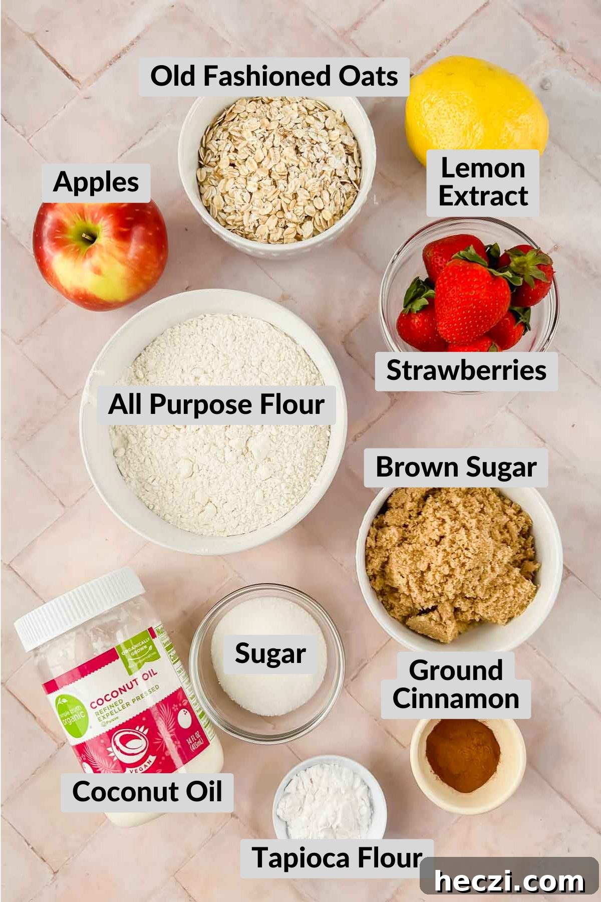 strawberry apple crisp ingredients in individual bowls on pink tiled background.