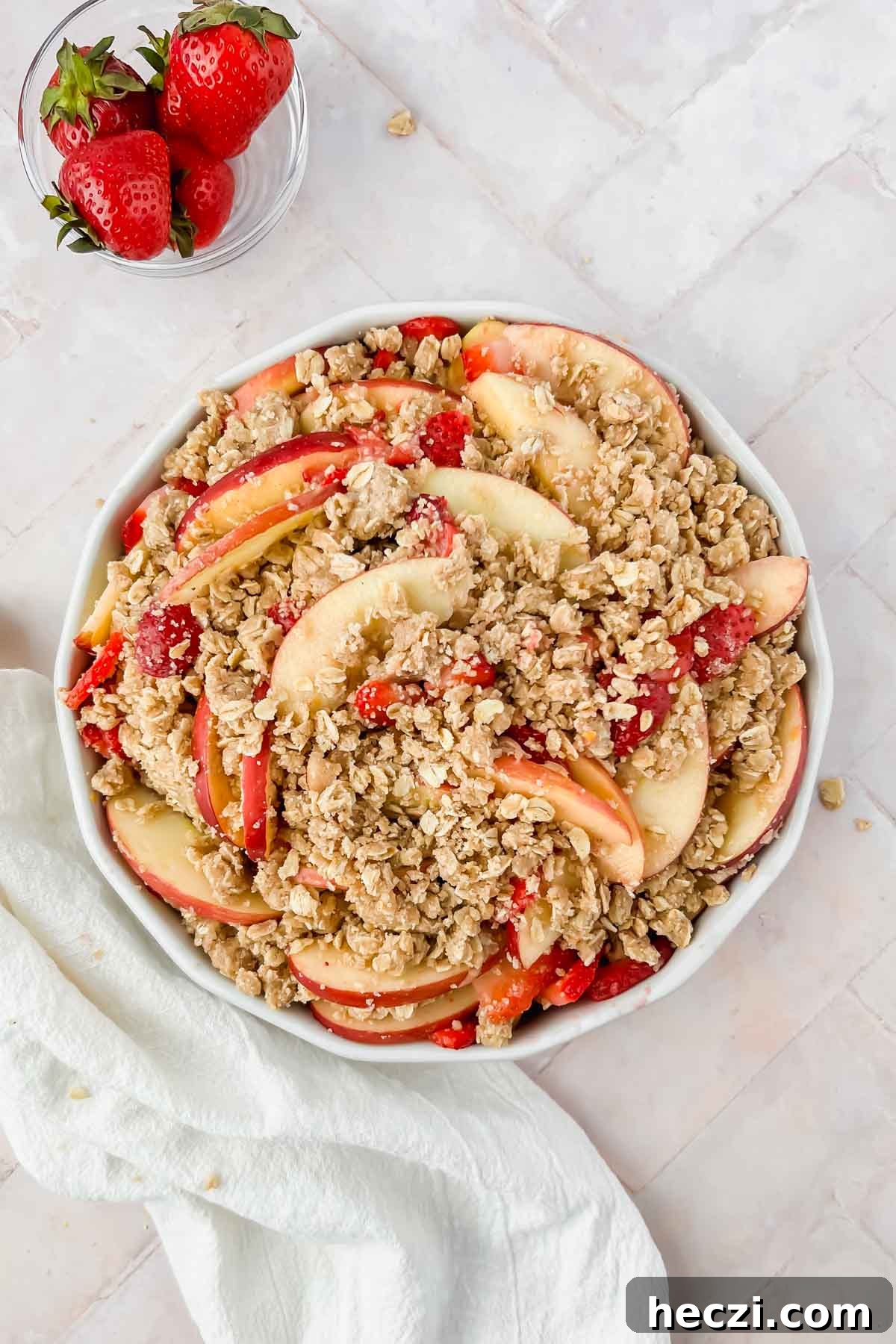strawberry apple crisp with oatmeal streusel topping before baking.