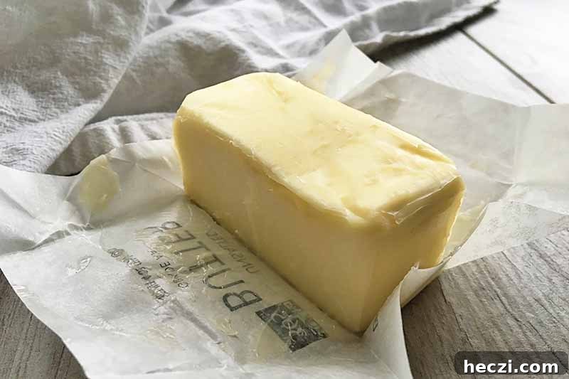 Horizontal image of a stick of butter unwrapped.