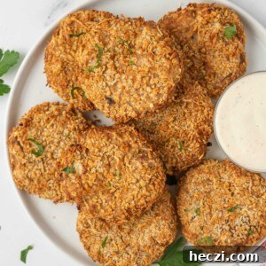 Crispy Parmesan-Crusted Tuna Patties with Lemon Aioli 8 A plate with crispy tuna cakes and a dipping sauce for serving.