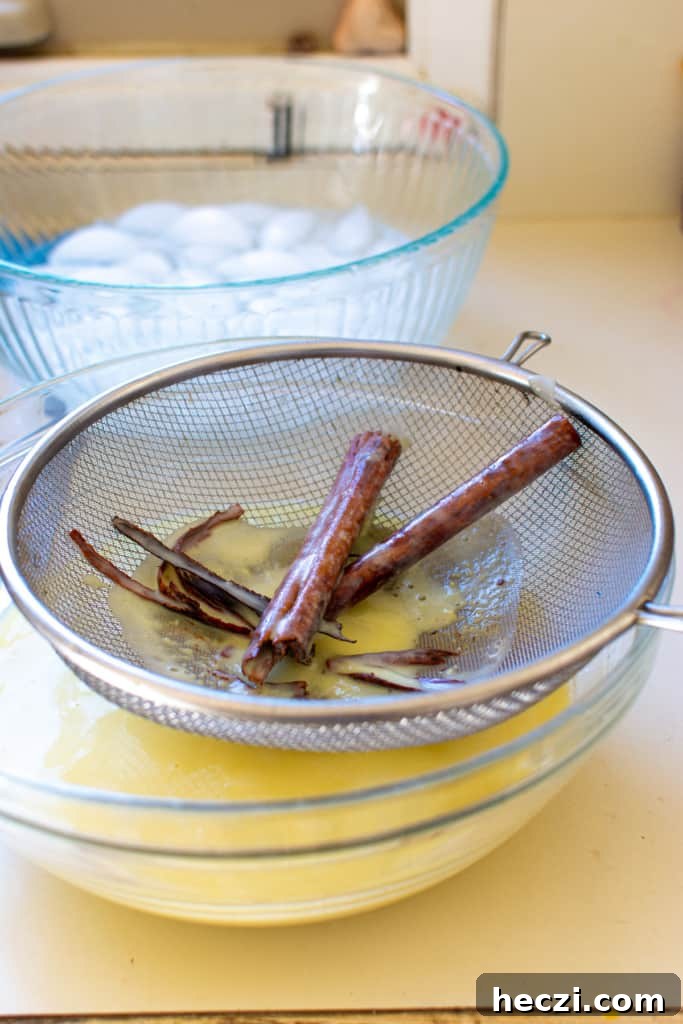 Mexican Cinnamon Ice Cream Recipe — Creamy Horchata-Style Ice Cream 10 Canela ice cream custard being strained.
