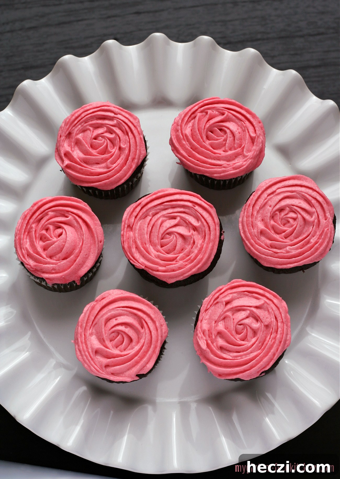 Gluten-Free Chocolate Cupcakes with Fresh Raspberry Frosting 2 gluten-free chocolate raspberry cupcakes on white cake plate