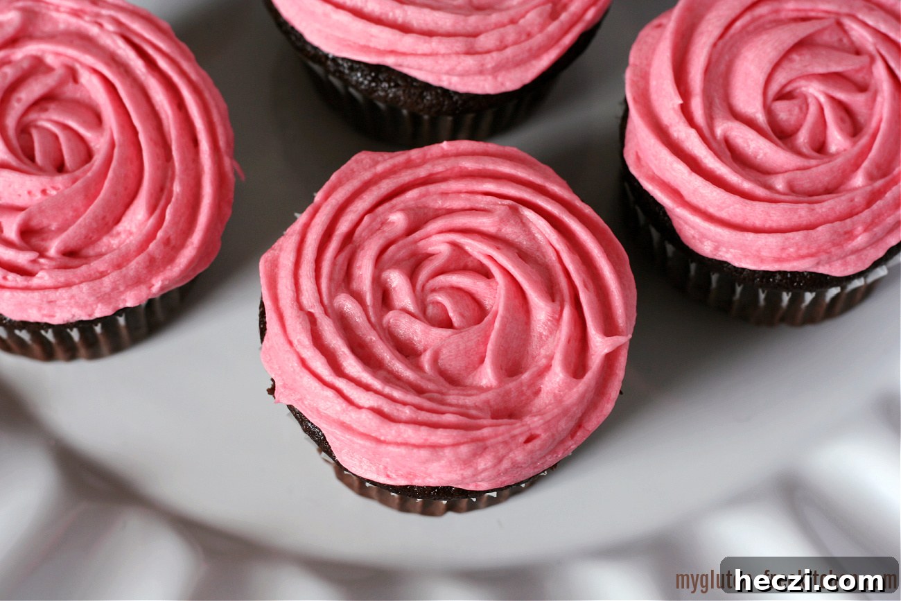 Gluten-Free Chocolate Cupcakes with Fresh Raspberry Frosting 3 white plate with gluten-free chocolate cupcakes with swirled pink frosting