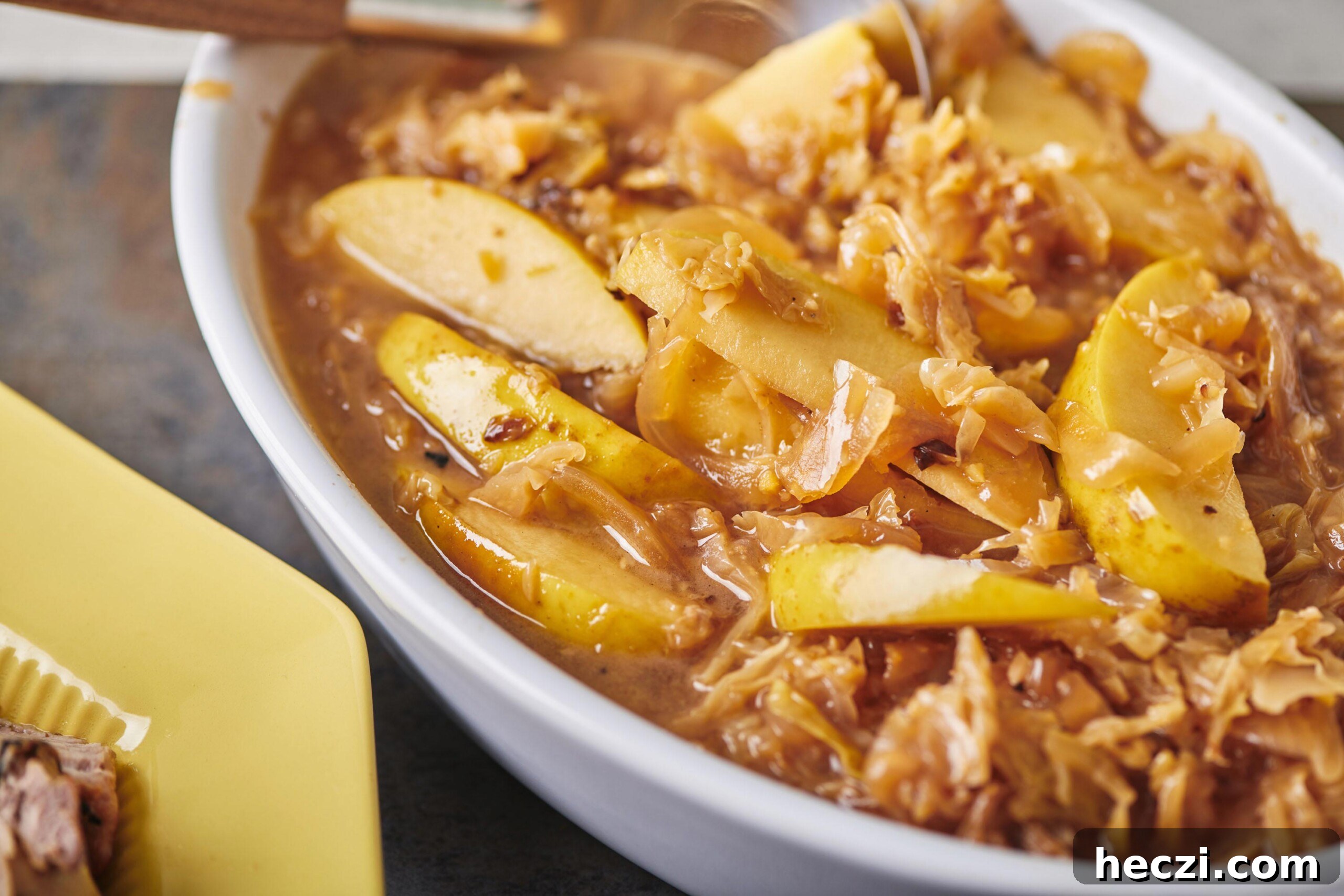 How to Cook Cabbage: Simple Recipes and Perfect Techniques 6 Slow Cooker Fall-Apart Braised Pork with Cabbage and Apples in serving dish.