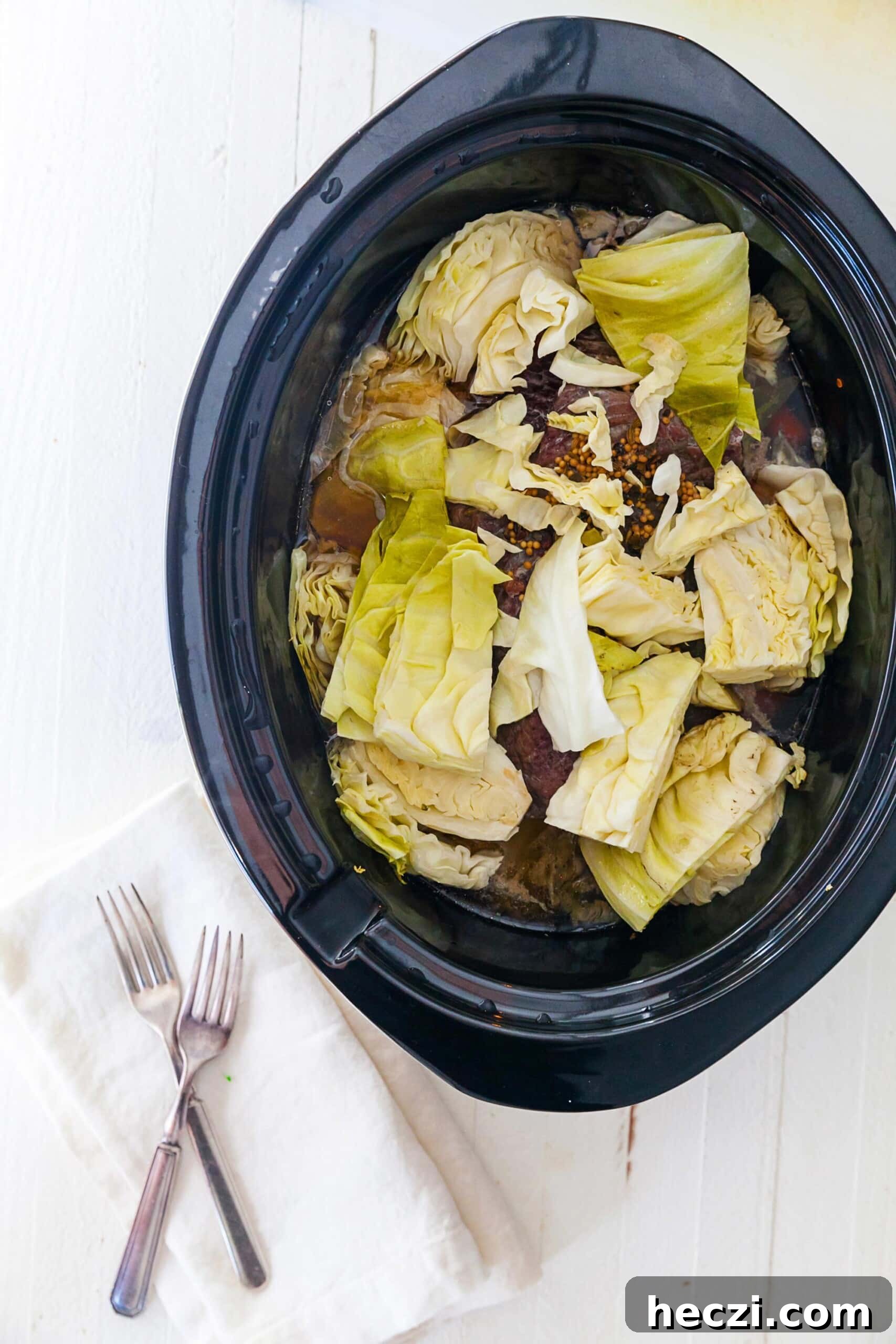 How to Cook Cabbage: Simple Recipes and Perfect Techniques 7 Corned Beef and raw cabbage in slow cooker.