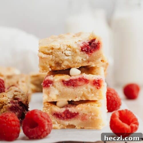 A stack of raspberry white chocolate blondies.