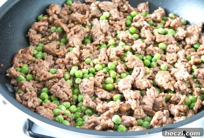 Rustic Sausage Rigatoni with Creamy Tomato Sauce 6 peas and Italian sausage in a pan