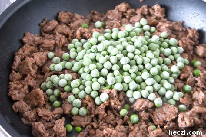 Rustic Sausage Rigatoni with Creamy Tomato Sauce 5 frozen peas and cooked Italian sausage