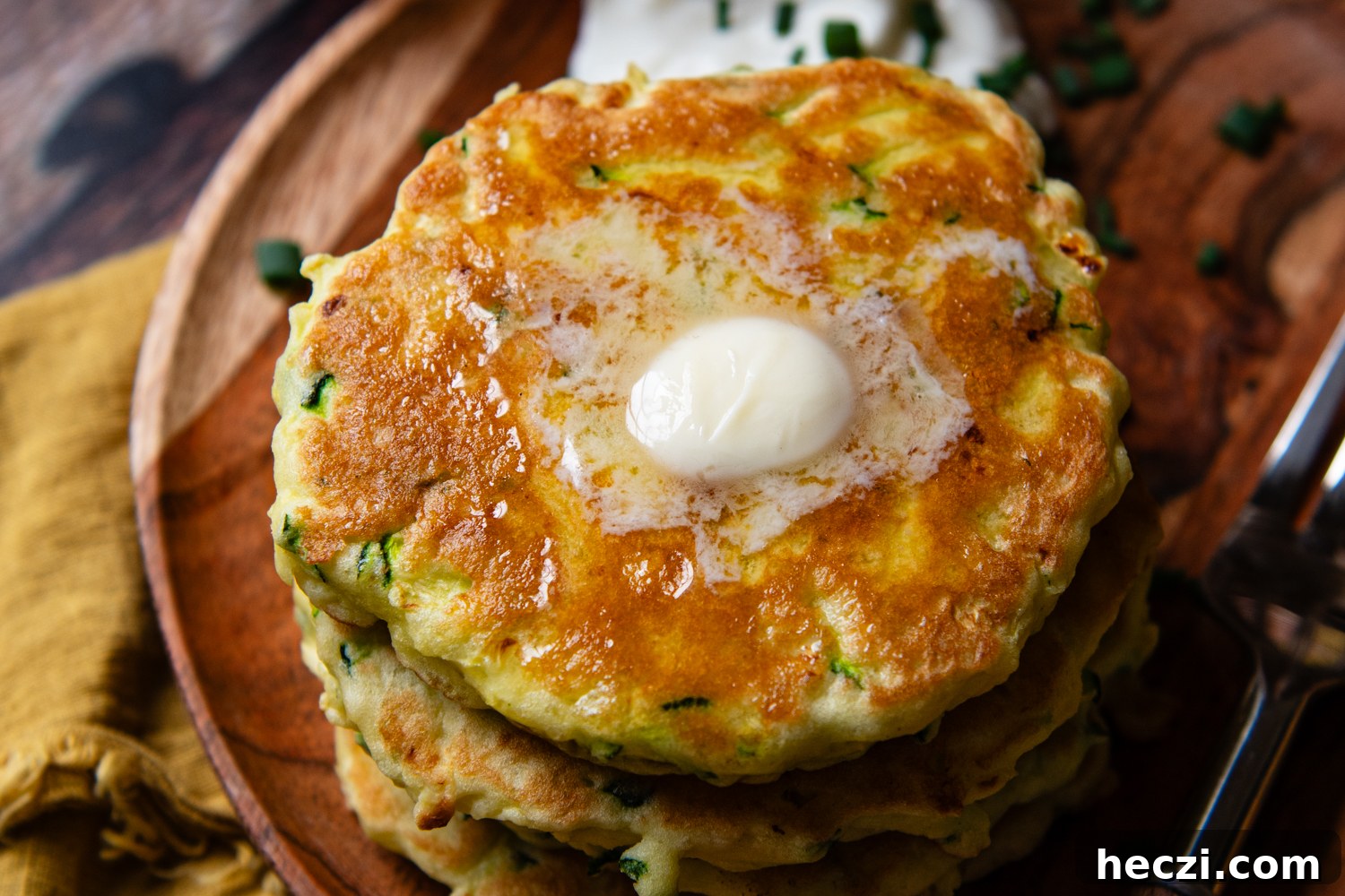 top view of zucchini pancake with warm butter melting on top.