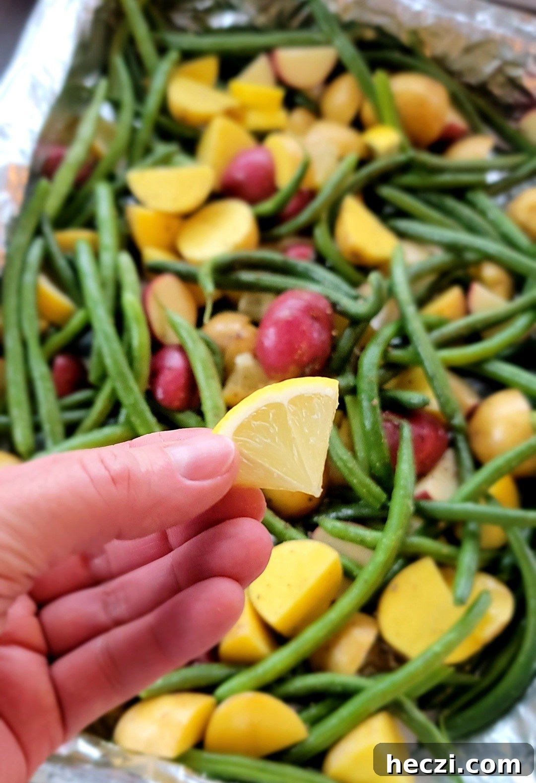 Potatoes quartered on baking sheet