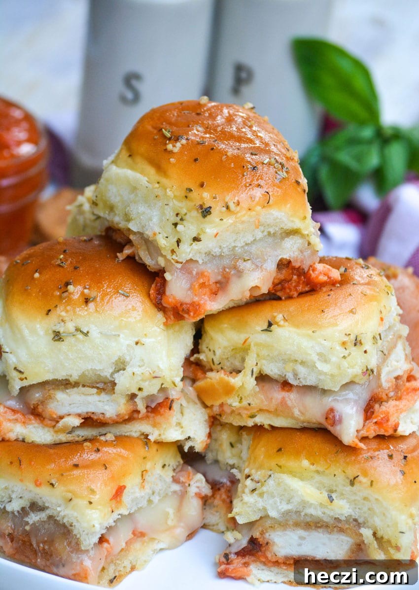 Chicken Parmesan Nugget Sliders Recipe for Crispy, Cheesy Bites 3 a stack of chicken nugget parmesan sliders on a white plate