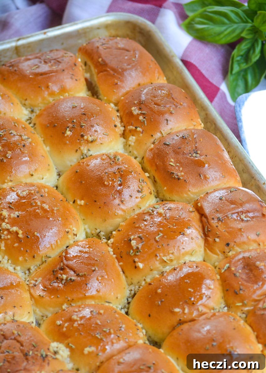 Chicken Parmesan Nugget Sliders Recipe for Crispy, Cheesy Bites 4 baked chicken parmesan nugget sliders on a silver baking sheet