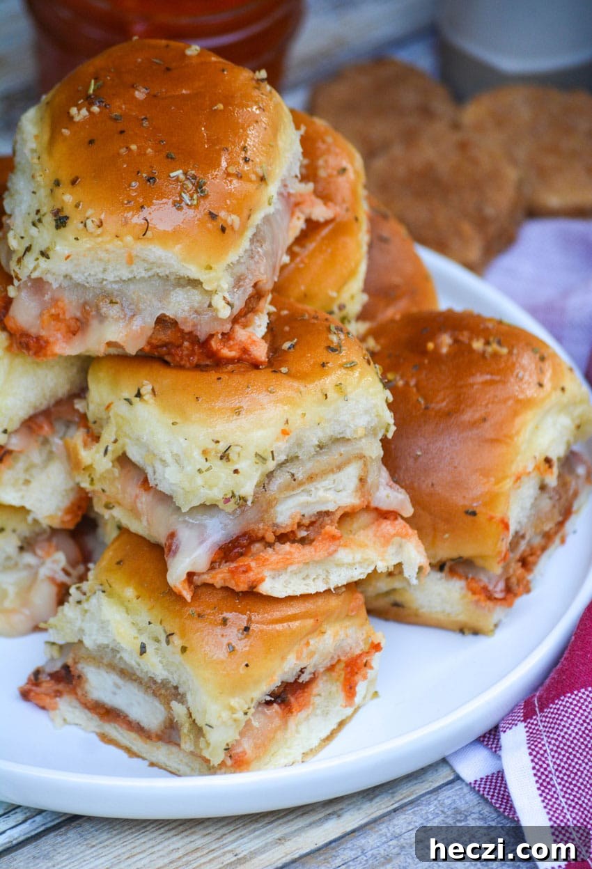 Chicken Parmesan Nugget Sliders Recipe for Crispy, Cheesy Bites 7 a stack of cheesy chicken parmesan nugget sliders on a white plate