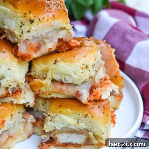 a stack of chicken nugget parmesan sliders on a white plate