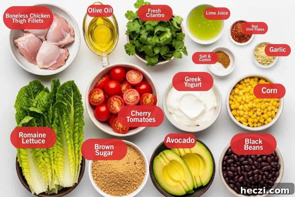 Southwestern Chicken Salad Recipe: Zesty Ingredients & Creamy Avocado 3 Flat lay photo of ingredient shot of boneless chicken thigh fillets, olive oil, fresh cilantro, lime juice, red chili flakes, garlic, salt and cumin, cherry tomatoes, romaine lettuce, brown sugar, avocado, black beans, greek yogurt, corn
