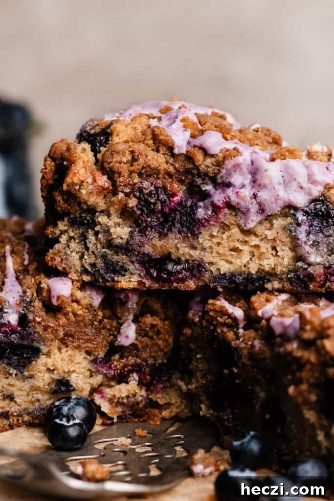 Blueberry Coffee Cake Recipe with Streusel Crumbs 9 A close-up on a slice of blueberry coffee cake.