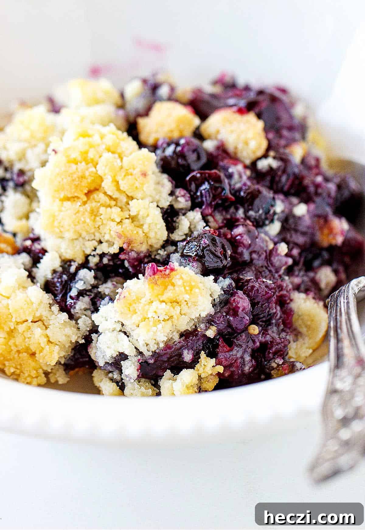a bowl of blueberry dump cake. 