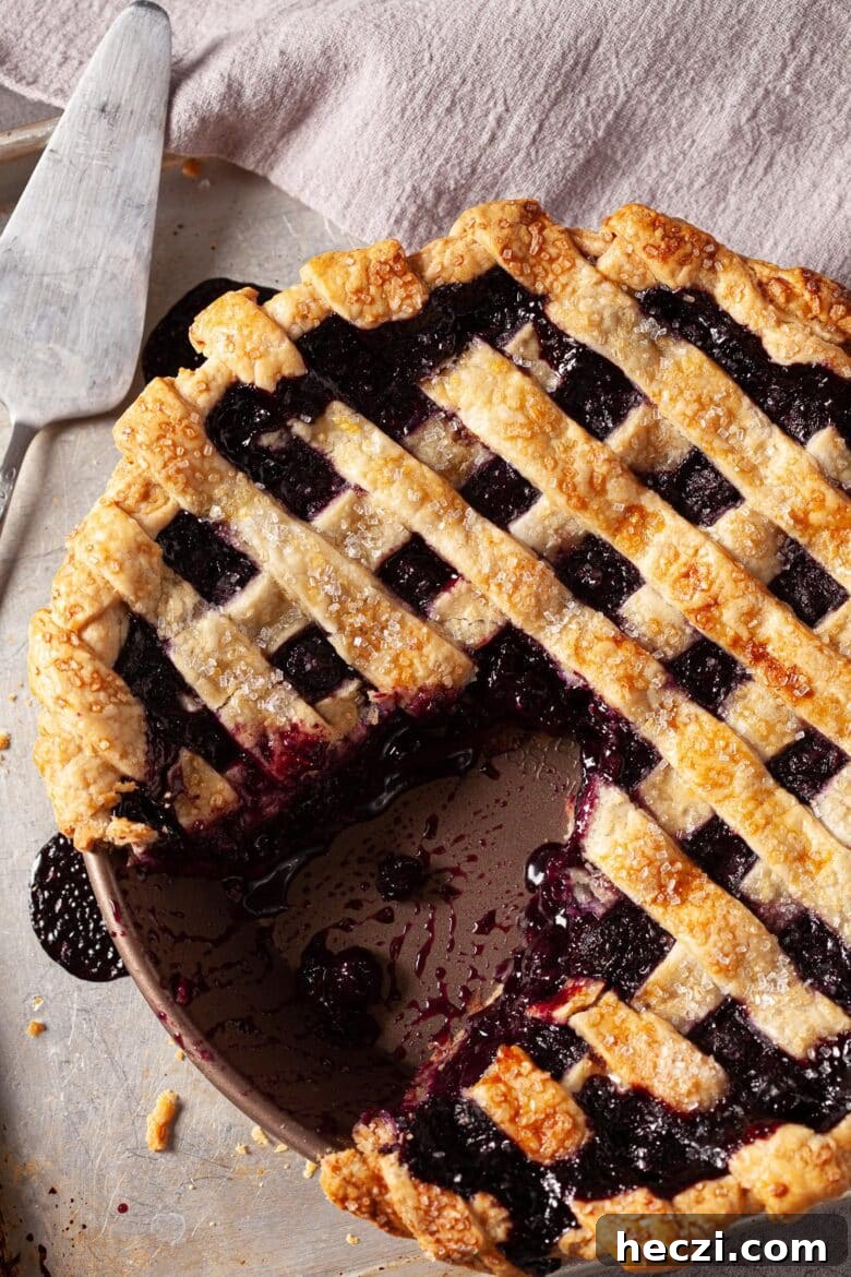 blueberry pie with a slice cut out of it. 