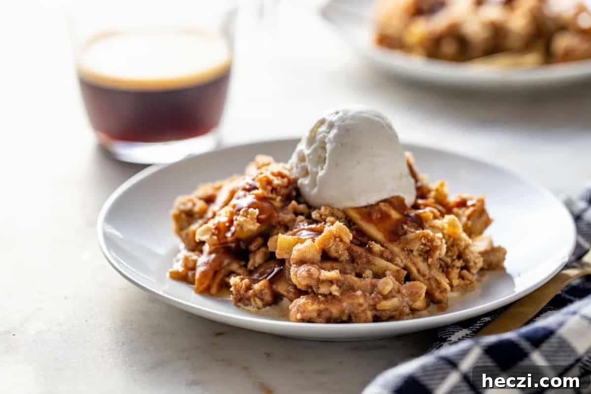 Warm Caramel Apple Crisp with Crunchy Oat Topping 9 Caramel apple crisp topped with vanilla ice cream, ready to be served