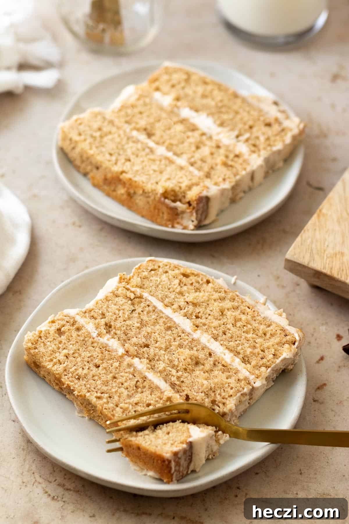 slices of chai cake on round plates with a gold fork