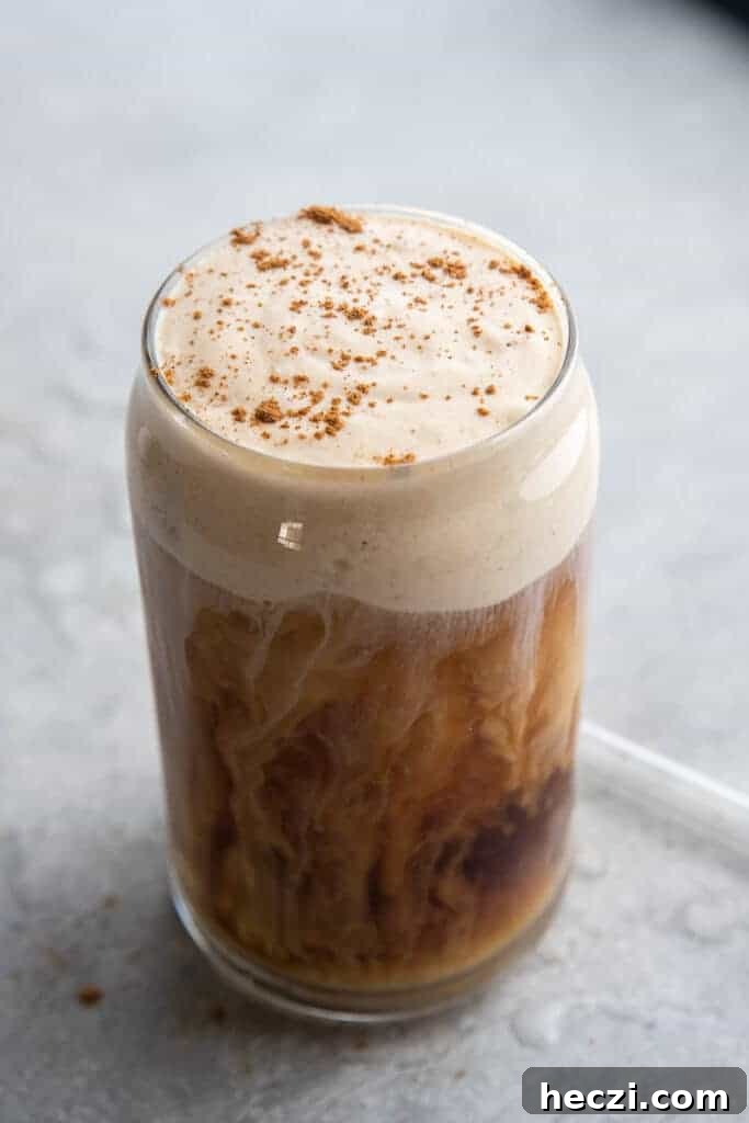 Starbucks Pumpkin Cream Cold Brew Review: Flavor, Price & Tips 9 Cream swirls in coffee