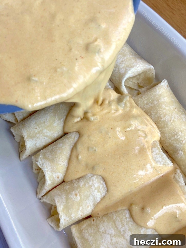 Creamy White Chicken Enchiladas Recipe for Comforting Dinner 4 Creamy White Chicken Enchiladas Recipe -- So quick and easy to make for busy weeknight dinners with your family! Fast to throw together after work, and made with cheap ingredients including rotisserie chicken, sour cream and cream cheese.