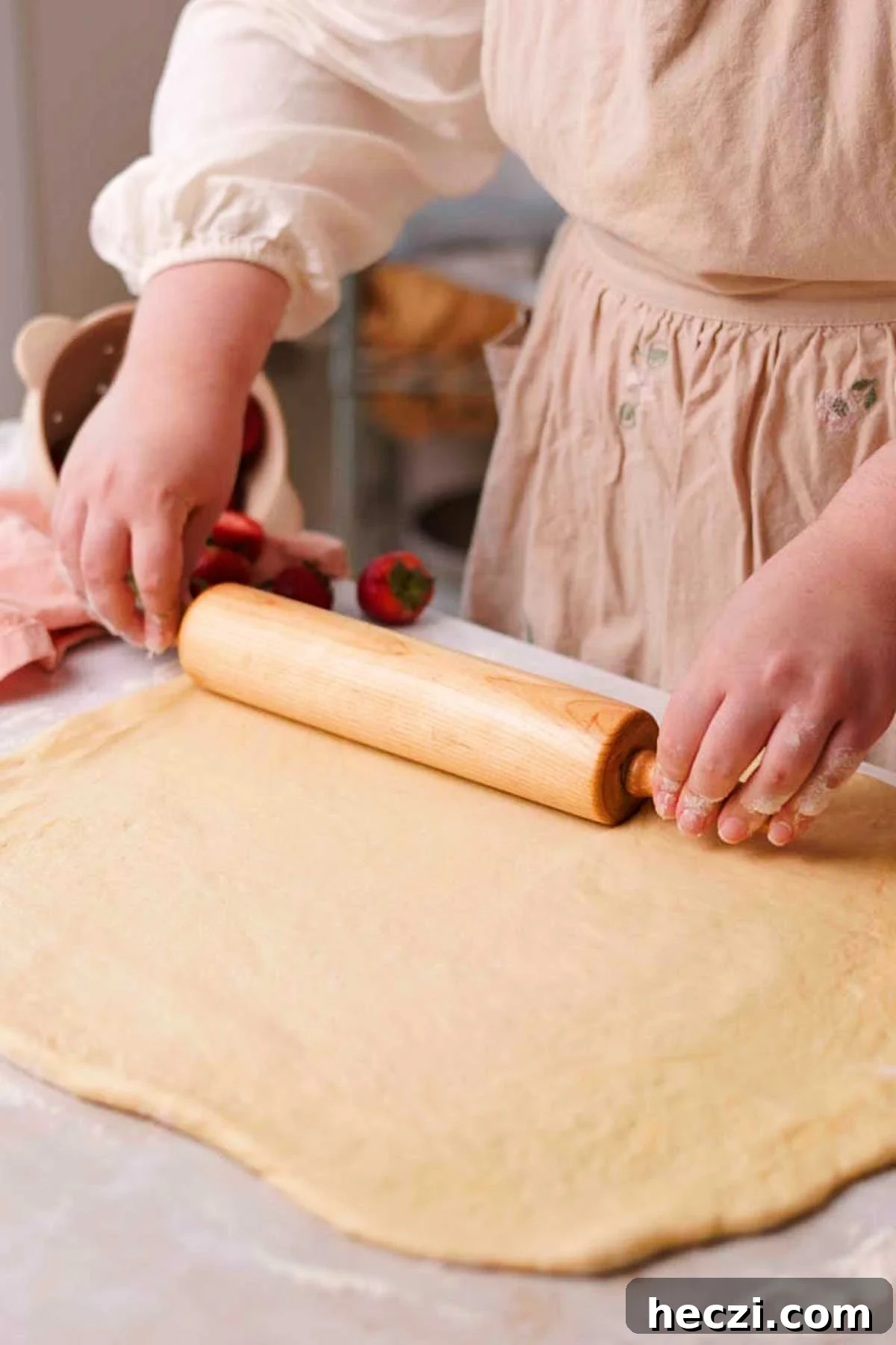 Strawberry Cinnamon Rolls with Cream Cheese Glaze 12 rolling out dough on a lightly floured surface with a rolling pin