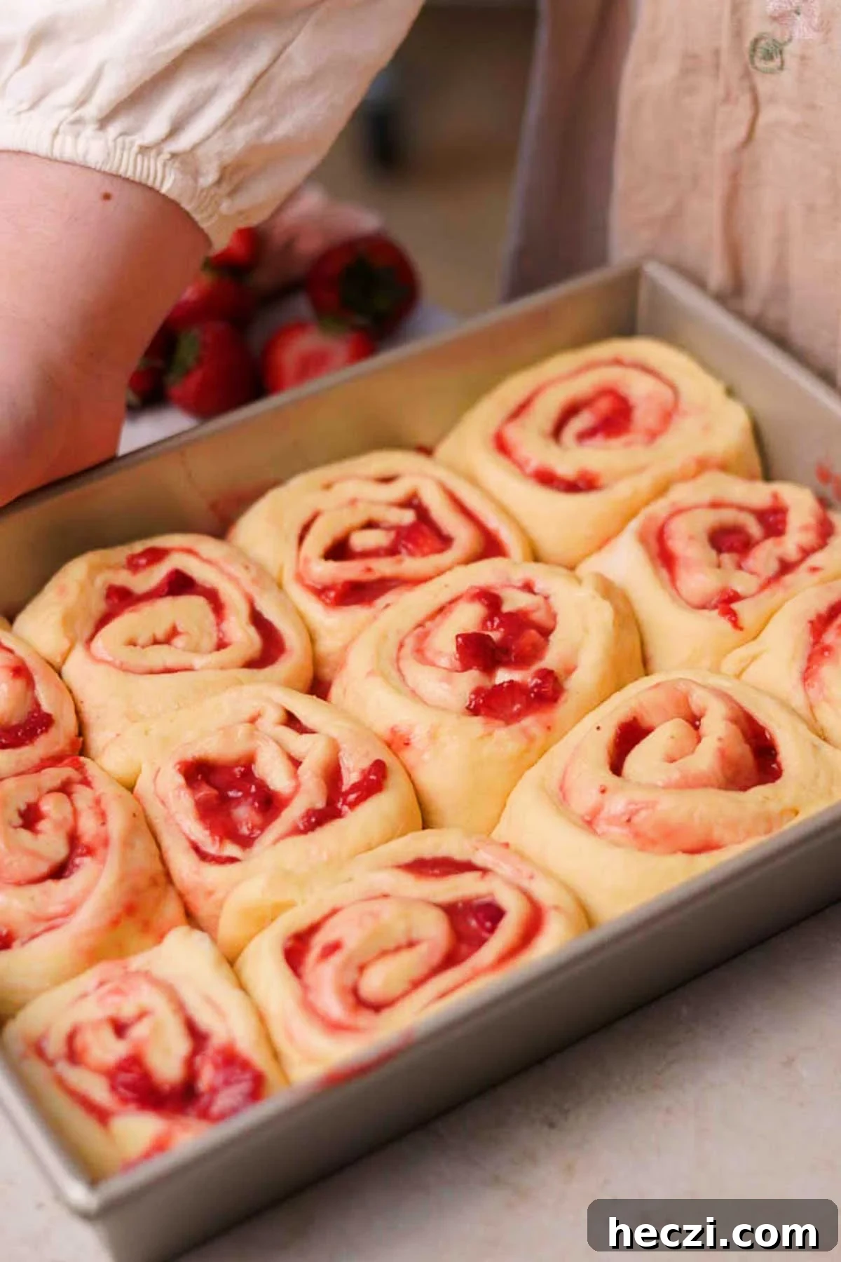 Strawberry Cinnamon Rolls with Cream Cheese Glaze 16 risen strawberry cinnamon rolls in rectangular baking pan