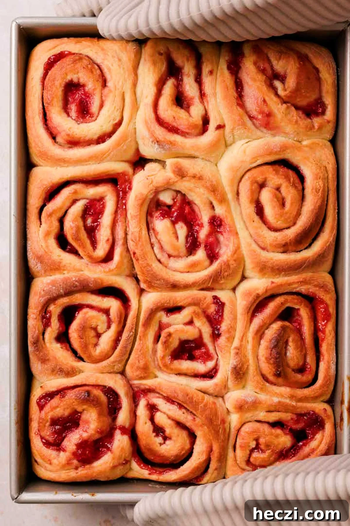 Strawberry Cinnamon Rolls with Cream Cheese Glaze 19 baked golden brown strawberry cinnamon rolls