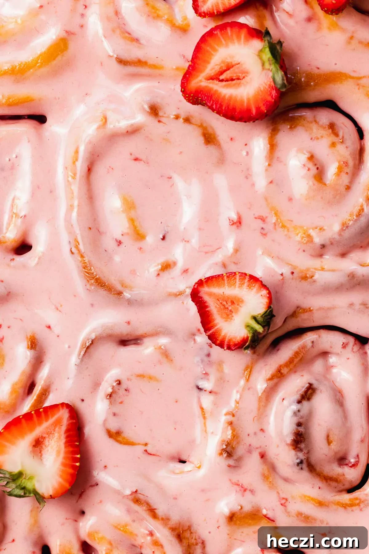 Strawberry Cinnamon Rolls with Cream Cheese Glaze 21 closeup of the strawberry cream cheese glaze on top of strawberry cinnamon rolls