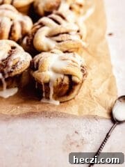 cinnamon rolls on parchment paper with spoon