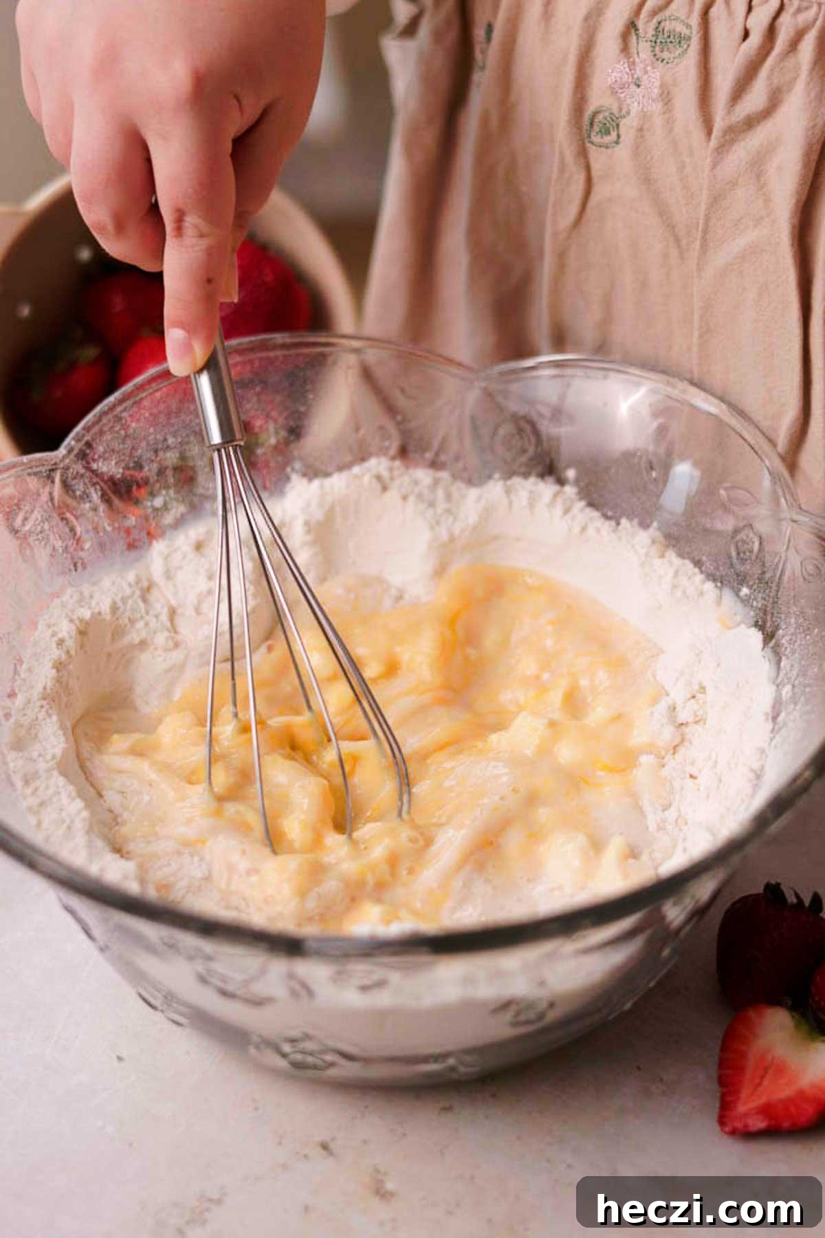 Strawberry Cinnamon Rolls with Cream Cheese Glaze 8 whisking wet ingredients inside of a flour well in a large glass bowl