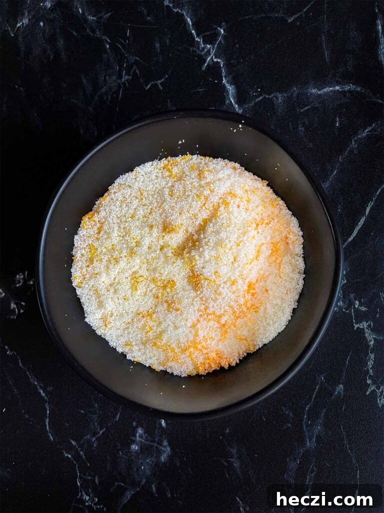 Homemade Holiday Spice Flat White Recipe 4 Tangerine zest mixed with the granulated sugar in a dark bowl.