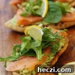 Pea, Mint & Feta Avocado Boats: Fresh Stuffed Avocado Recipe 4 Smoked salmon bruschetta with smashed avocado and feta lined up on a wooden board from above.