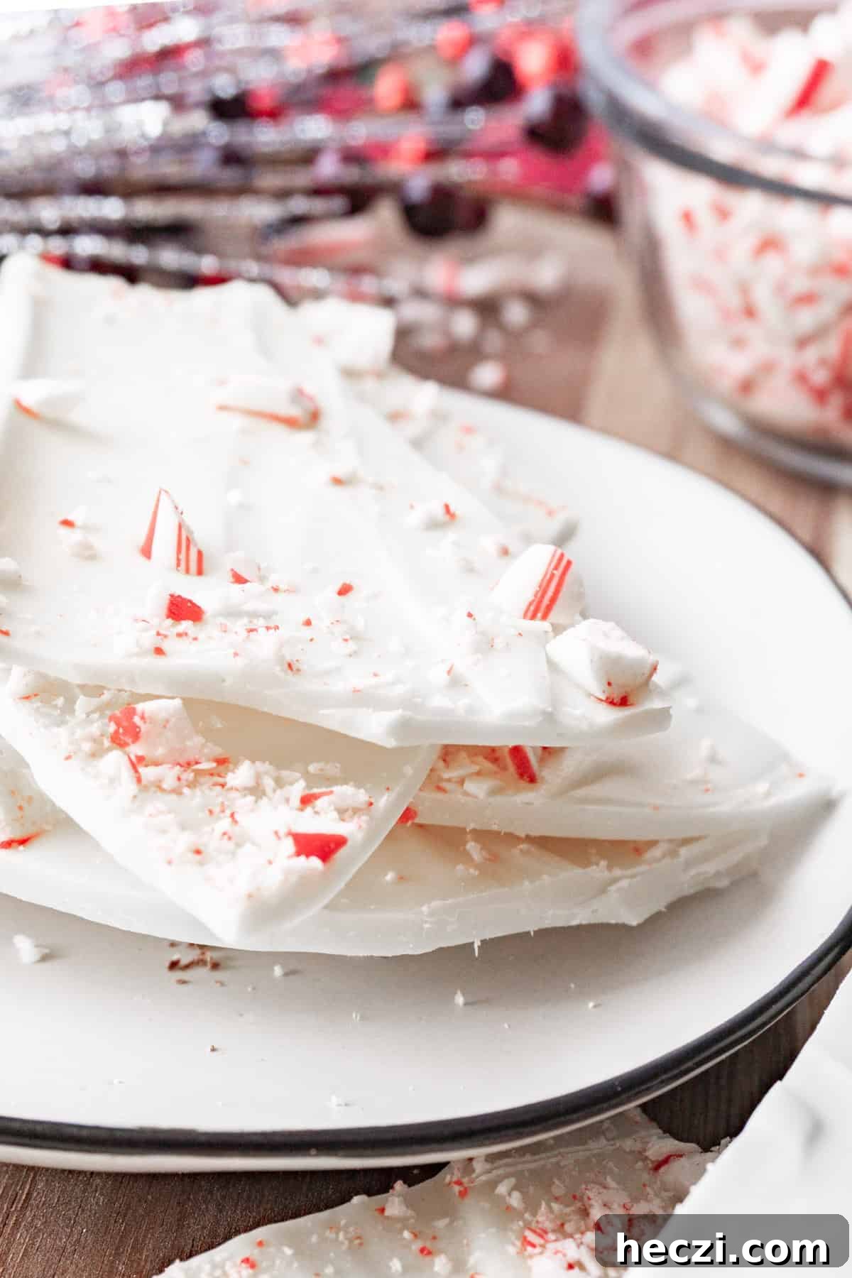 Homemade Peppermint Bark Recipe: Quick Holiday Chocolate Candy 4 white chocolate peppermint bark on plate.