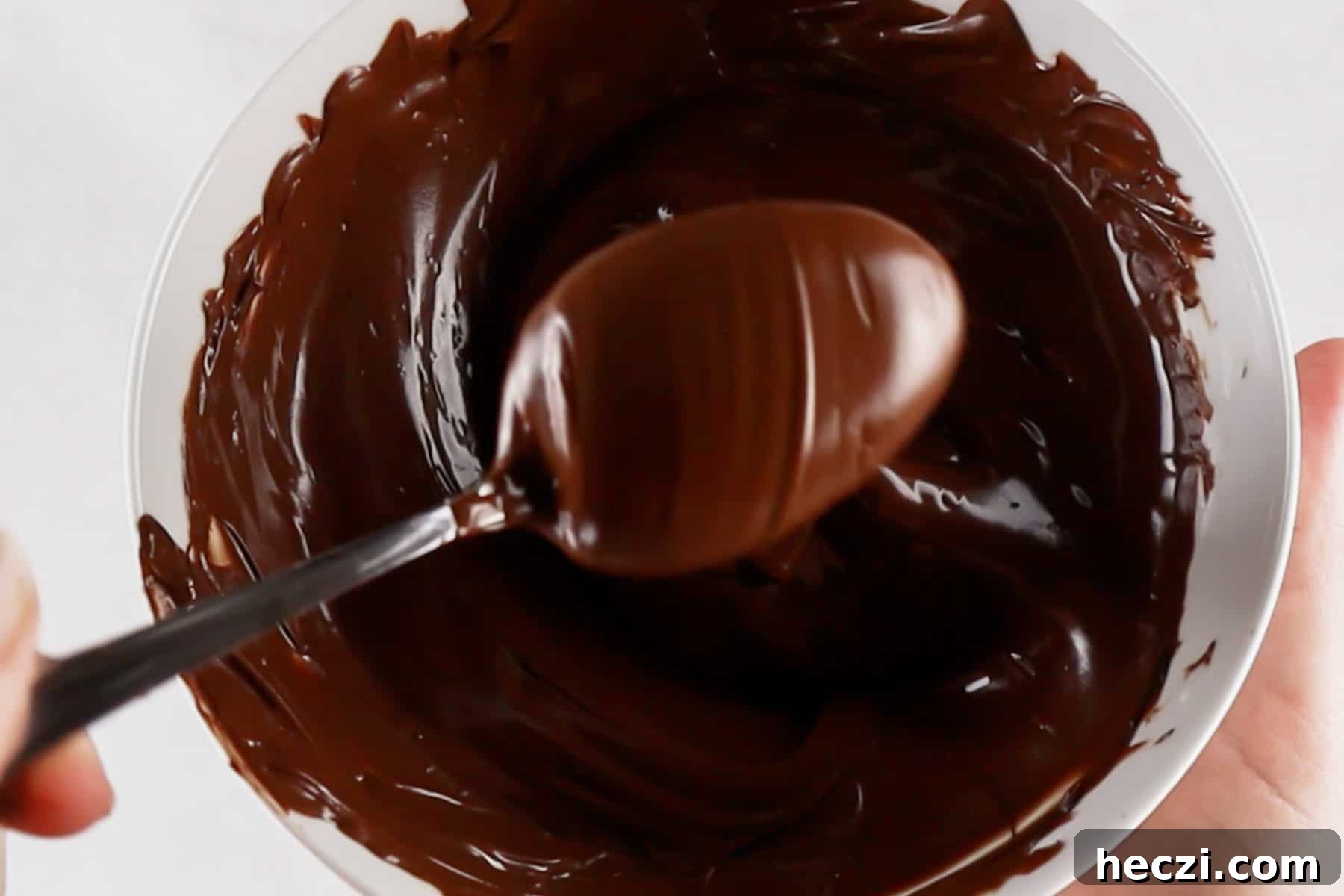 Homemade Peppermint Bark Recipe: Quick Holiday Chocolate Candy 5 Melted chocolate in white bowl.
