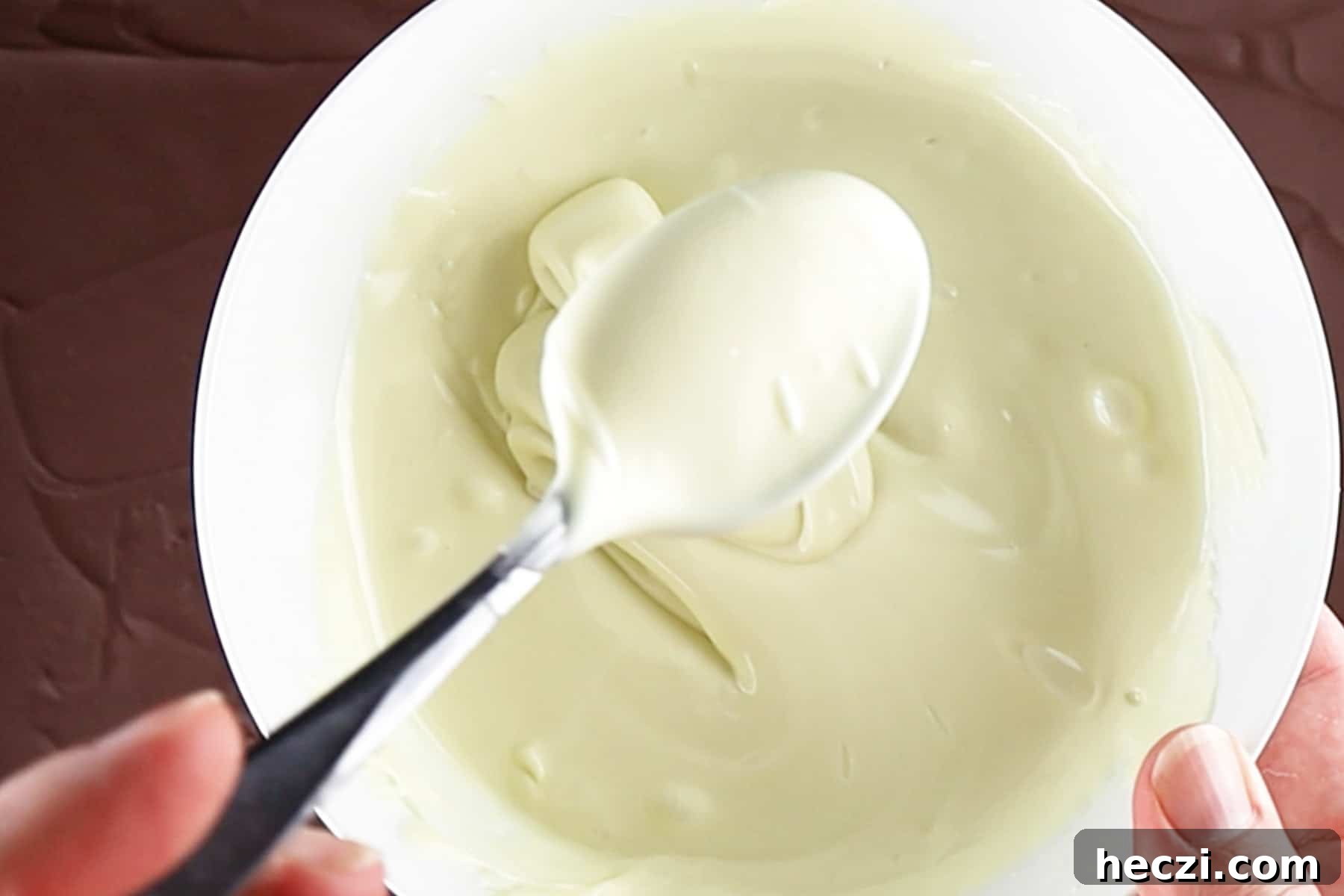 Homemade Peppermint Bark Recipe: Quick Holiday Chocolate Candy 7 melted white chocolate in white bowl.