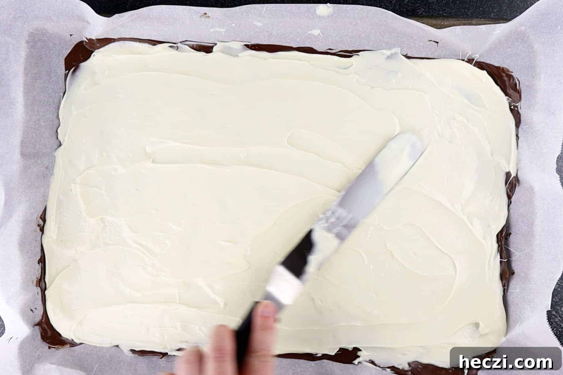 Homemade Peppermint Bark Recipe: Quick Holiday Chocolate Candy 8 spreading white chocolate over milk chocolate layer