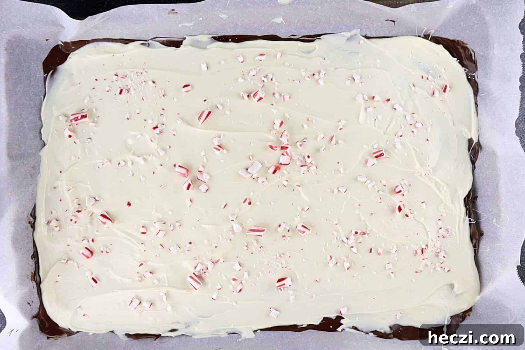 Homemade Peppermint Bark Recipe: Quick Holiday Chocolate Candy 9 peppermint bark with crushed candy canes after it as chilled and is completely set.