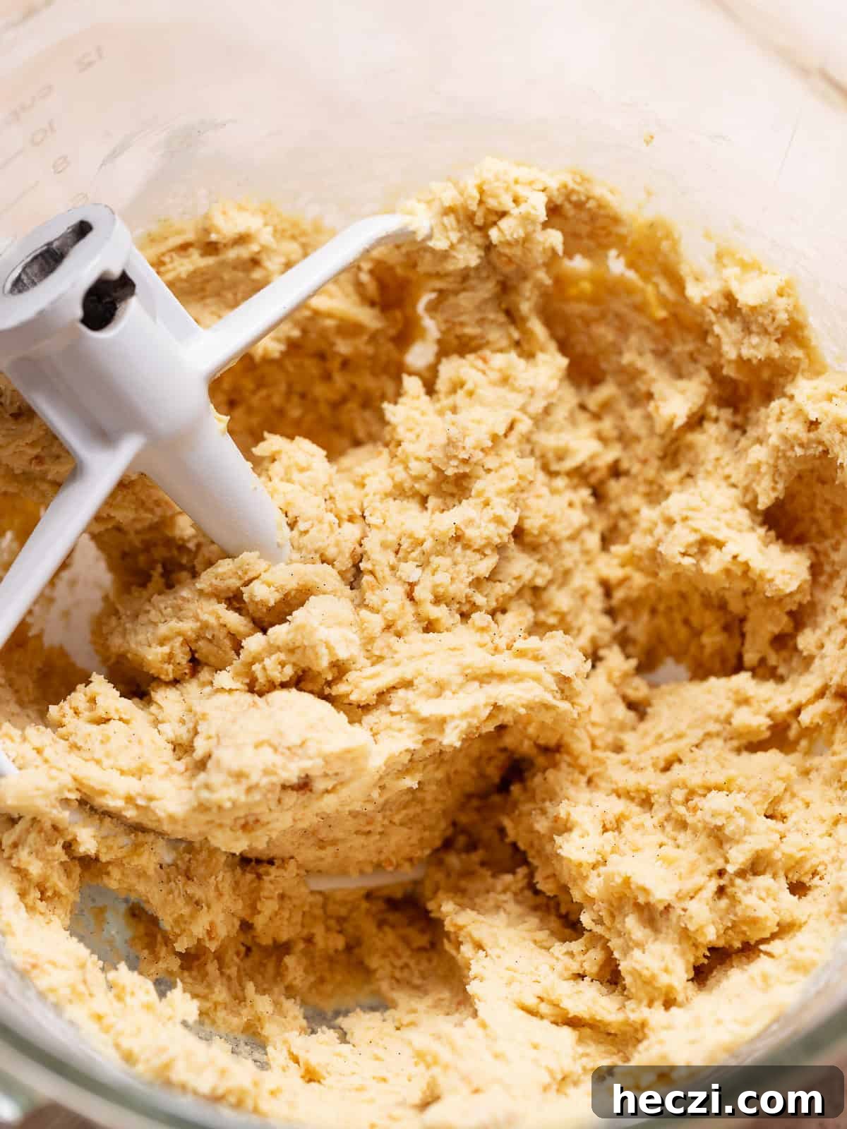 Vanilla shortbread dough mixed in a stand mixer bowl.