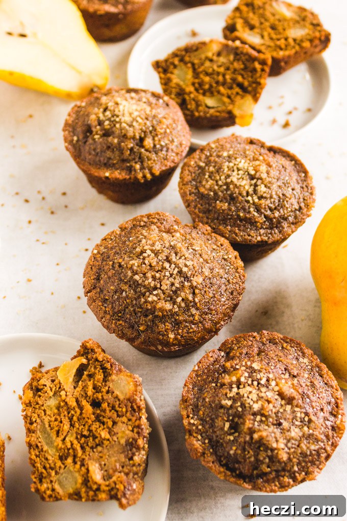 Gluten-Free Gingerbread Pear Muffins — Moist Spiced Breakfast Treat 7 Close up of muffin with pear chunks.