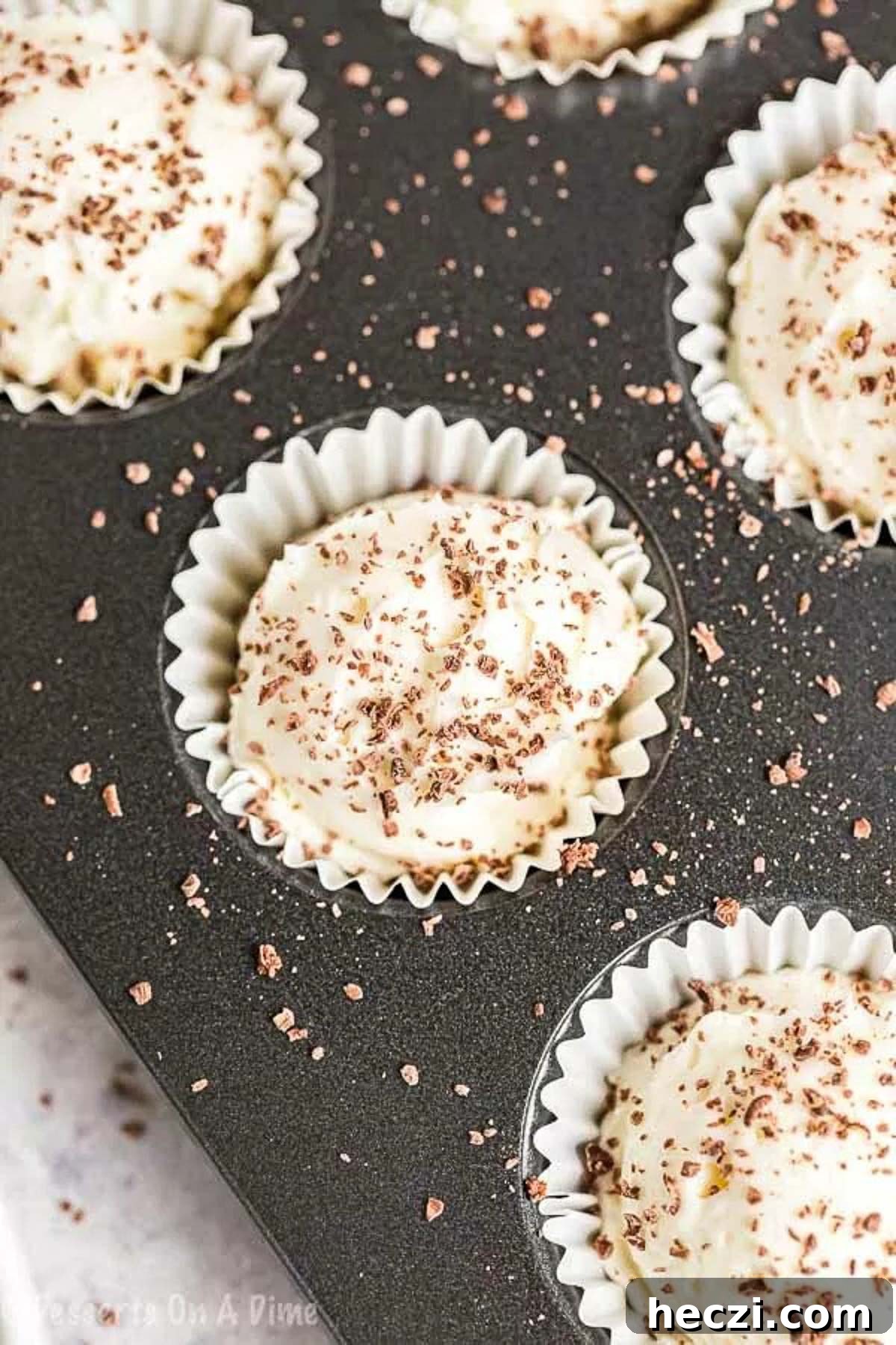 Keto Cheesecake Fat Bomb Recipe for Low-Carb Snacks 5 Keto Cheesecake Fat bombs in a cupcake holder in a muffin pan.