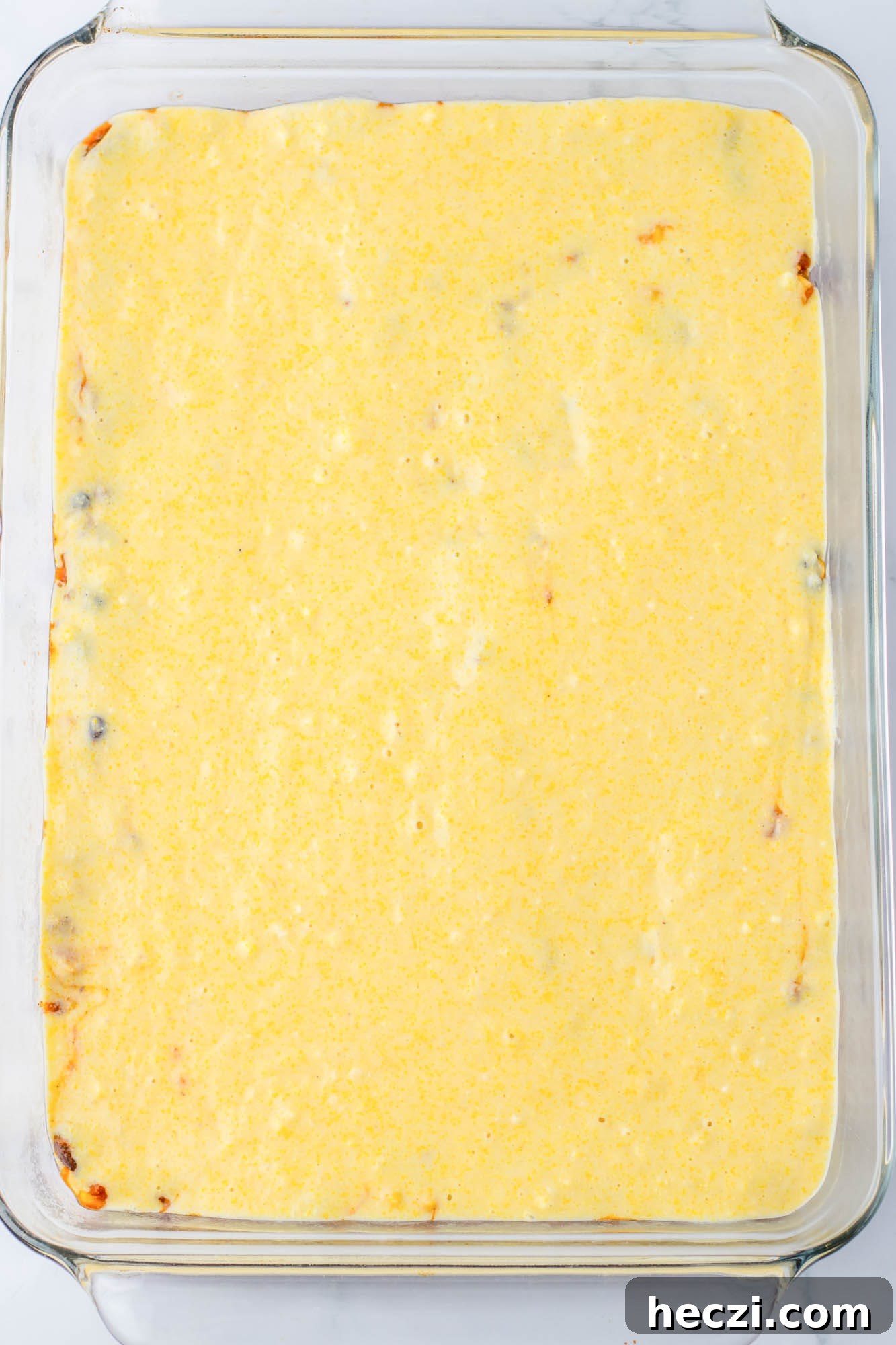 Spreaded cornbread batter on a casserole