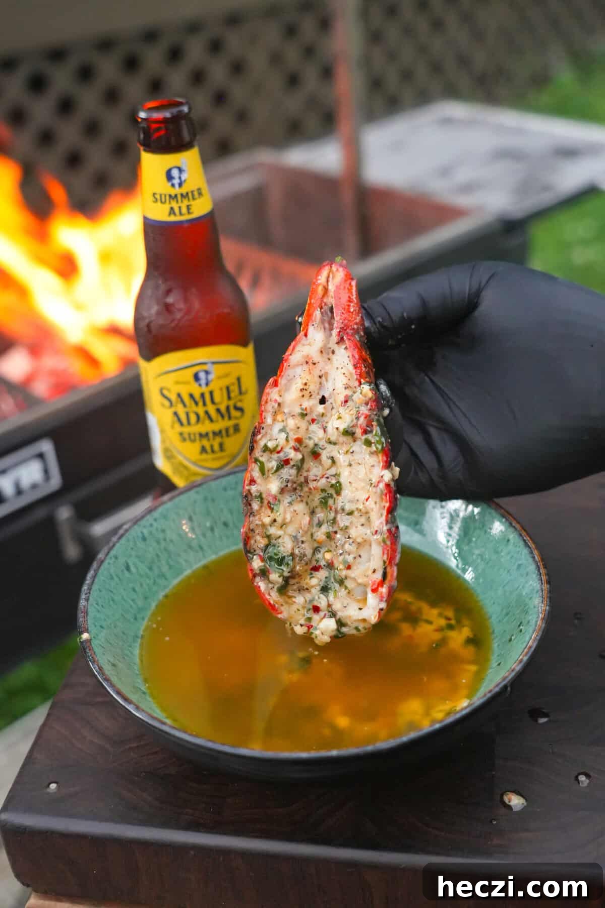 Beer-Butter Grilled Lobster Tails Recipe for Summer BBQ 3 The lobster tail is dipped in the beer butter and it's pure heaven.