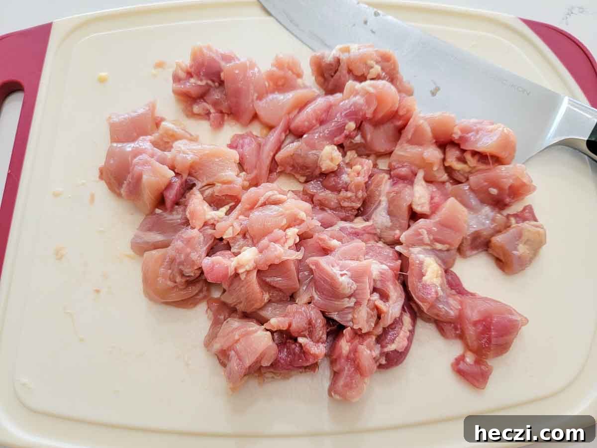 chicken diced on a cutting board.