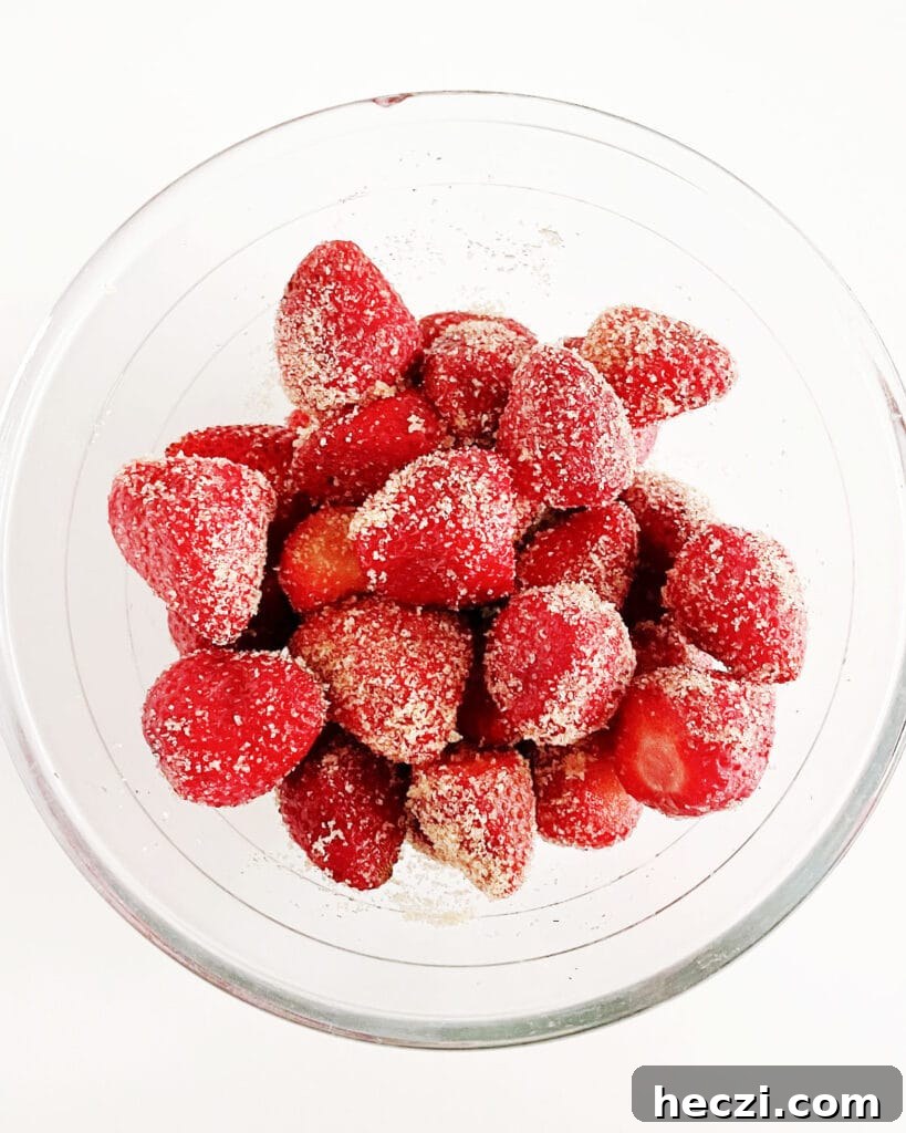 4-Ingredient Strawberry Compote Recipe for Fresh Homemade Jam 4 Brown sugar and strawberries in a glass bowl.